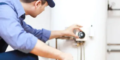 plumber-inspecting-water-heater-tank-westerville-oh plumber inspecting water heater tank in Columbus, Ohio Water Heaters provides water heaters installations, repair and replacement.